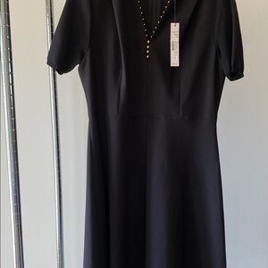 Tahari classic black dress  size 8 . Short sleeve,pleated front.Very flattering